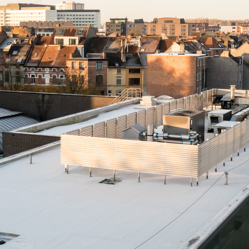 view from above of a commercial flat roof covered in a white roof membrane