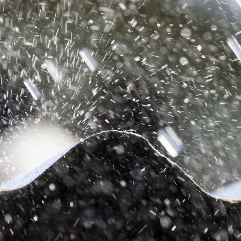 close-up of rain falling on a metal roof