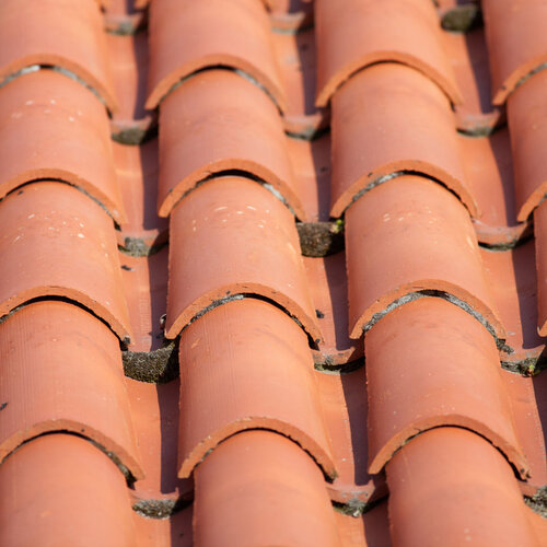 close-up of a roof constructed with red clay tiles