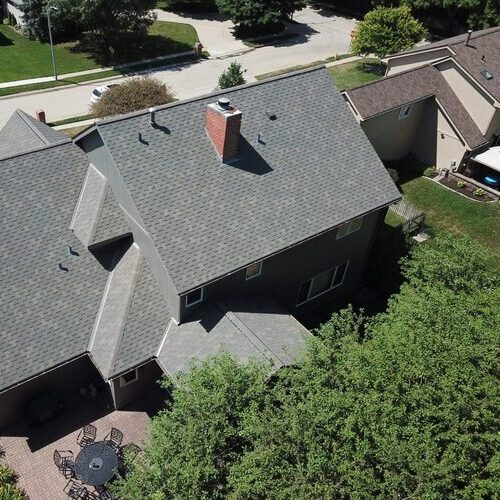 view from above of a home with a shingle roof