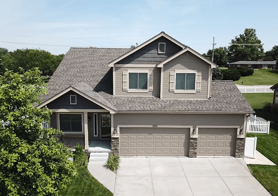 brick home with shingle roof