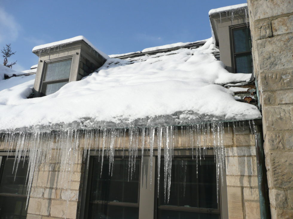 ice dam and icicles along a roof