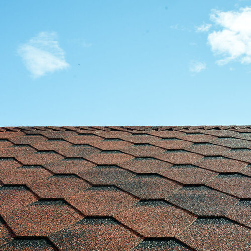 close-up of a roof covered in dark brown tiles