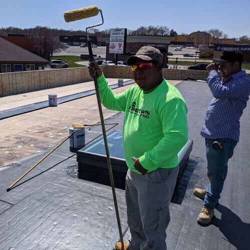 workers during single-ply roofing installation 